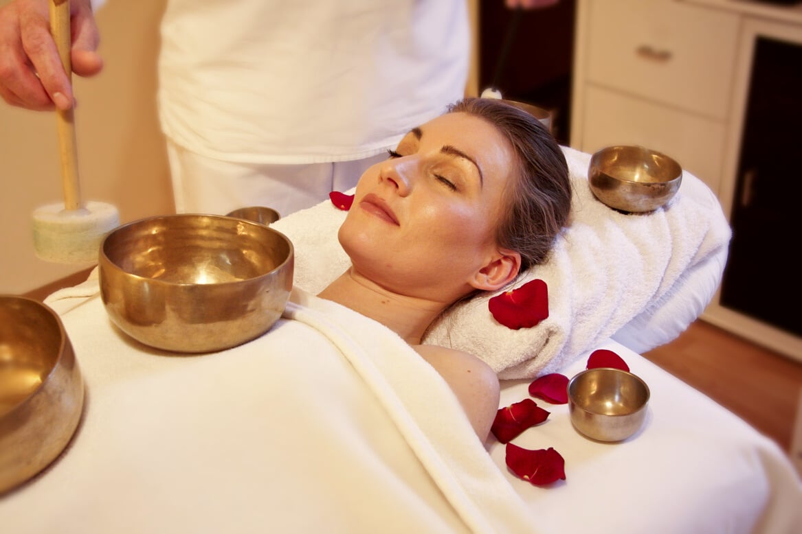 Woman Having a Singing Bowl Massage